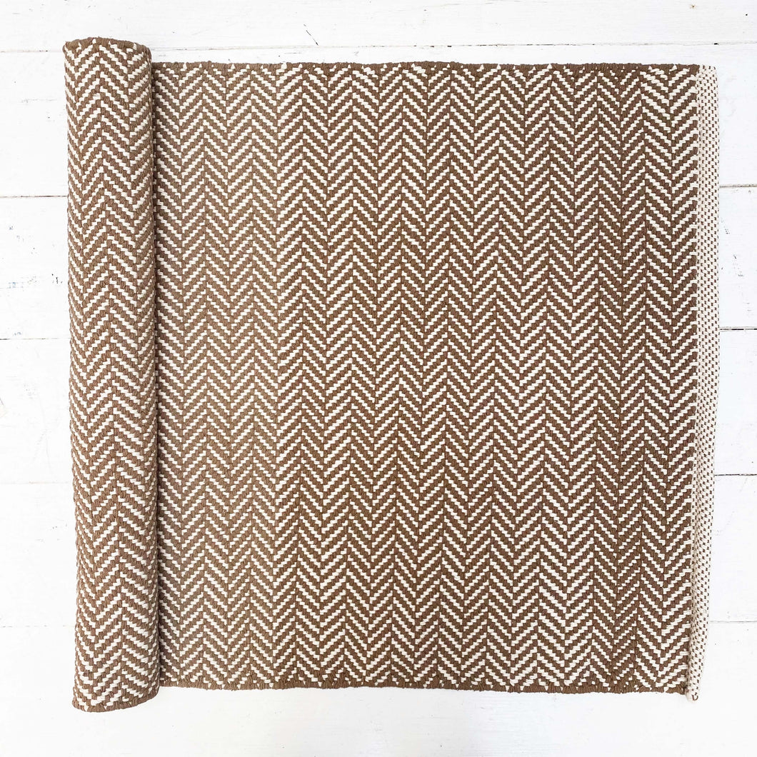 brown and cream herringbone patterned cotton rug