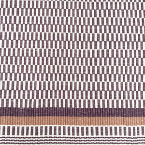 brown and white rug with brown and striped border