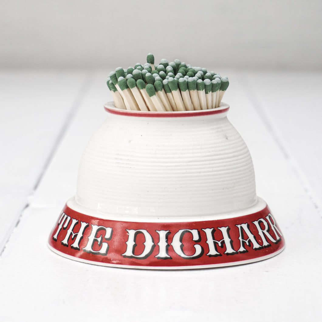 white porcelain match strike container with red base and white letters