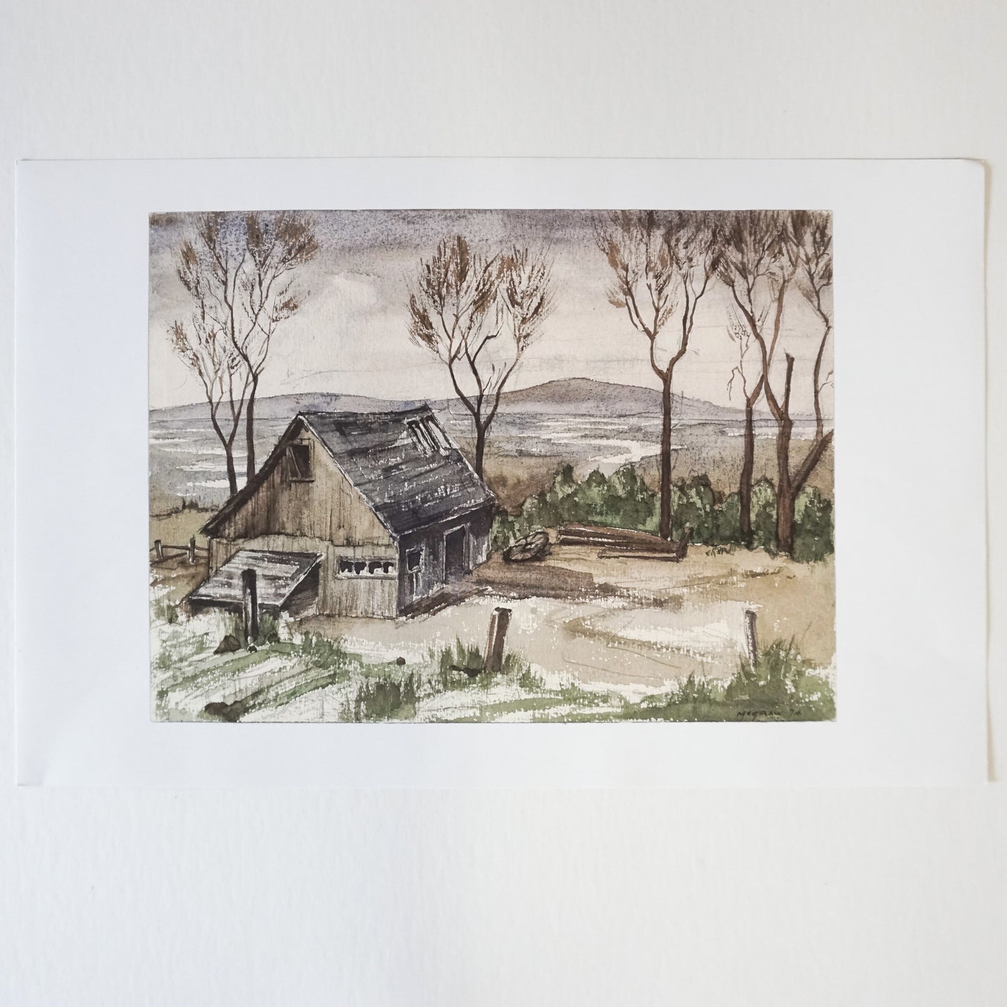 wood barn with trees and mountains in background  Edit alt text