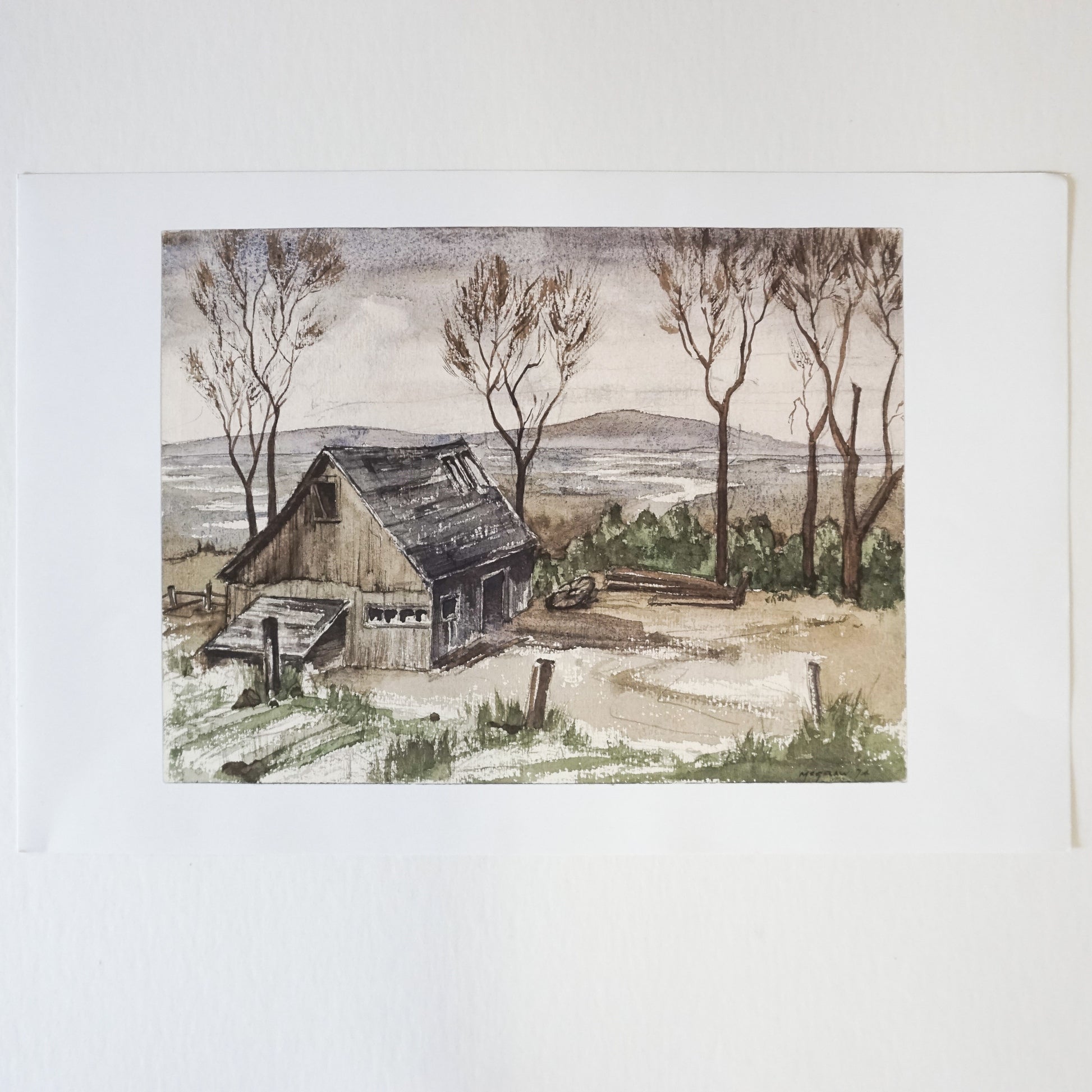 wood barn with trees and mountains in background  Edit alt text