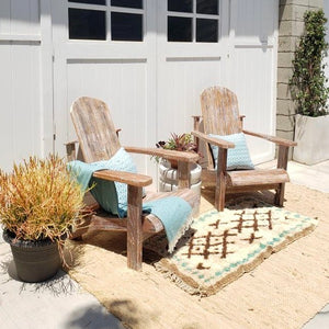 stained outdoor chairs distressed with random areas of white paint