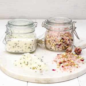 Sea salt and essential oil bath salts in glass container with clasp lid