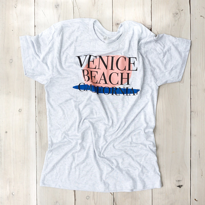 light gray tee shirt with black Venice Beach text and pink and blue background
