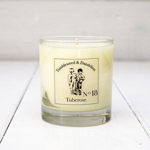 Clear glass candle, tuberose scent, Tumbleweed and Dandelion logo