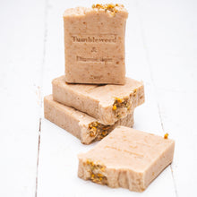 Load image into Gallery viewer, honey colored handmade soap with chamomile, honey and oat with tumbleweed and dandelion stamp