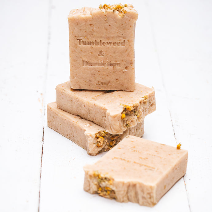 honey colored handmade soap with chamomile, honey and oat with tumbleweed and dandelion stamp