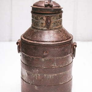 brown metal open container with rings on the side